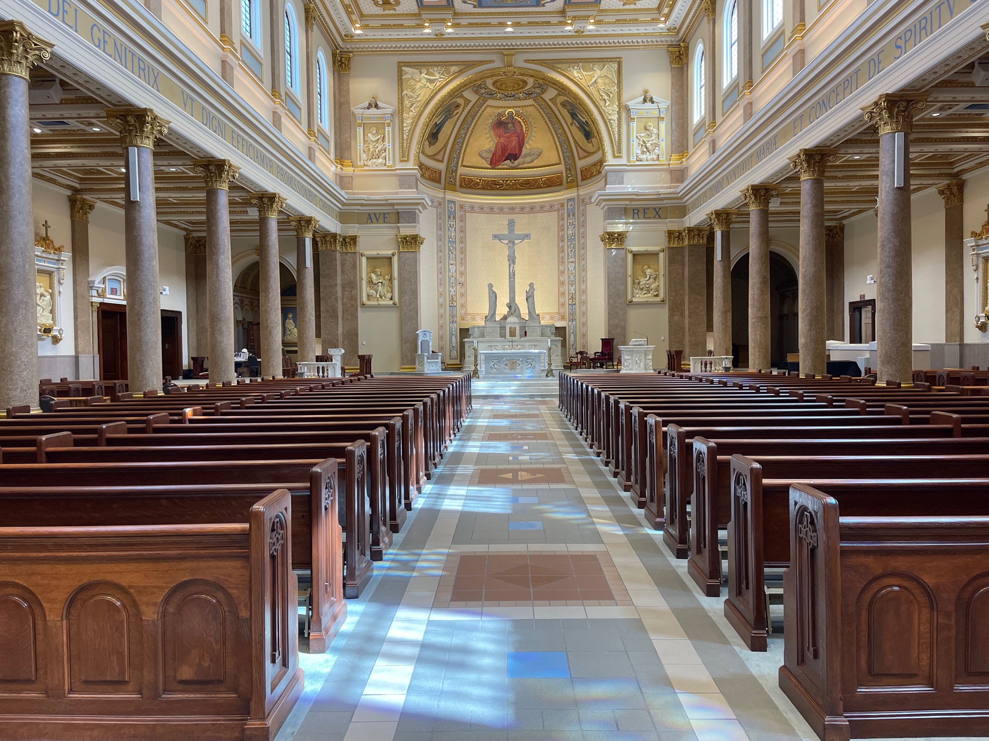 rear aisle view of refinished pews at Incarnation in Nashville, Tennessee after work performed by Wood Church Interiors